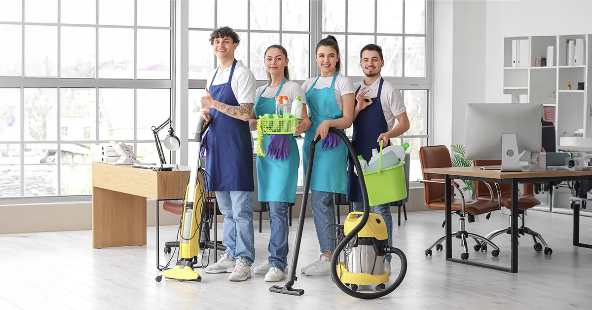 janitors with cleaning supplies in office